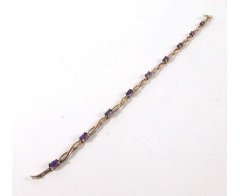A 9ct yellow gold bracelet set nine oval amethyst, overall 4.2 gms   CONDITION REPORT:  l. 18.5 cmWe use Mailboxes Etc for al