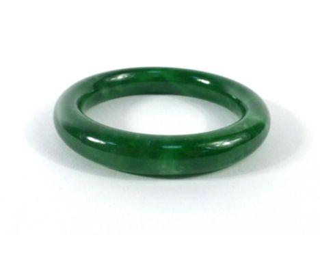 A dark green jade bangle, internal d. 5.8 cm