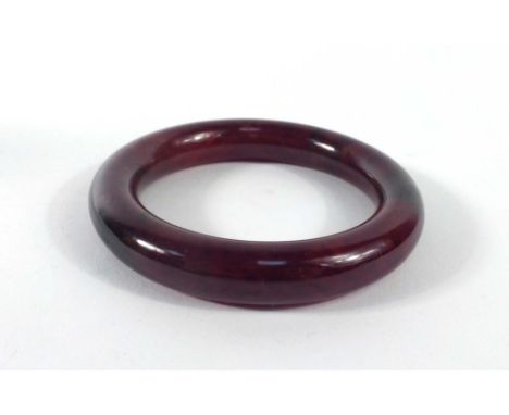 A brown jade bangle, internal d. 5.9 cm
