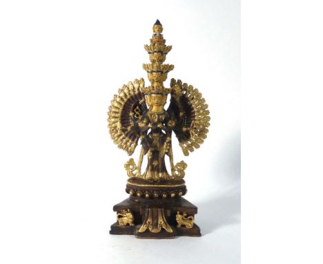 A brown patinated, gilt and enamel decorated figure in the form of Avalokiteshvara, h. 27 cm