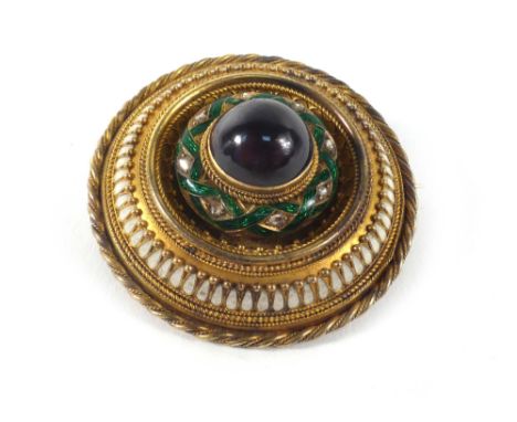 A 19th century yellow metal target-type brooch of Etruscan design having cabochon red glass within a green gillouche and diam