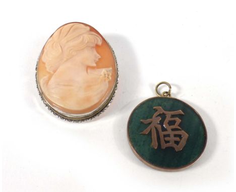 A 14ct yellow gold mounted circular jade pendant decorated with Chinese characters, d. 3.2 cm, together with a silver mounted