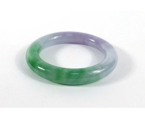 A purple/green jade bangle, internal d. 5.6 cm