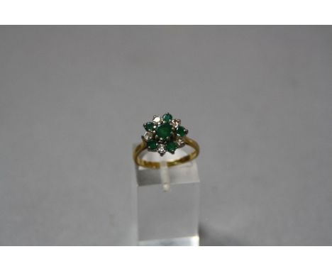 A LATE 20TH CENTURY EMERALD AND DIAMOND ROUND CLUSTER RING, estimated total round brilliant cut weight 0.45ct, colour assesse