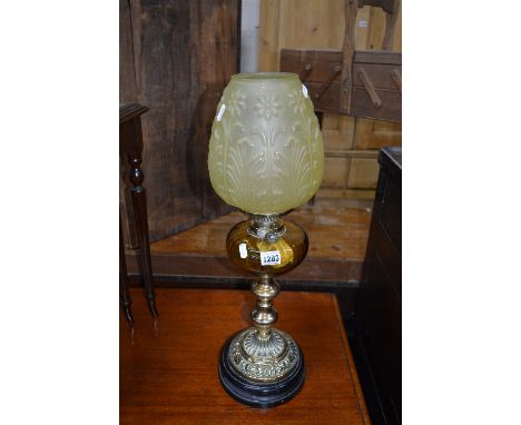 A VICTORIAN BRASS OIL LAMP, with yellow glass reservoir and shade
