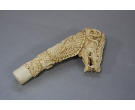 A FINE ANTLER CARVING OF A DRAGON, in the form of a walking stick handle, approximate height 15cm