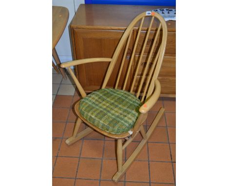 AN ERCOL ELM CHILDS SPINDLE BACK ROCKING CHAIR, with removable cushion