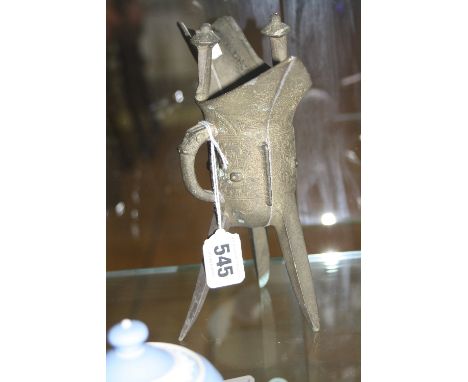 A CAST BRONZED LIBATION STYLE CUP, on a tripod base, height approximately 19cm