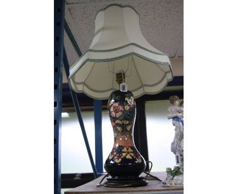 A MOORCROFT POTTERY OBERON PATTERN TABLE LAMP, mounted on a wooden plinth base, together with a pale green light shade, heigh