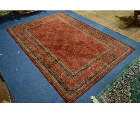 A RED GROUND HAND MADE CARPET, 100% wool 'royal Kesham Herati' label attached, approximate size 240cm x 170cm