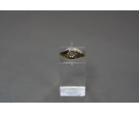 A MID-20TH CENTURY DIAMOND SINGLE STONE RING, one brilliant cut diamond illusion set in a fancy cross over two tone setting, 