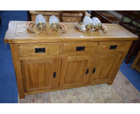 A LIGHT OAK SIDEBOARD, with three short drawers, approximate size width 139cm x depth 43cm x height 83cm