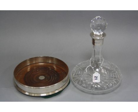 A MODERN SILVER DECANTER COASTER, plain exterior, mahogany inset base, maker J.A. Campbell, London 1991, diameter approximate