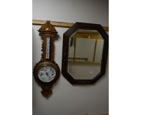 AN OAK FRAMED WALL MIRROR, and an oak cased aneroid barometer (sd, glass broken) (2)