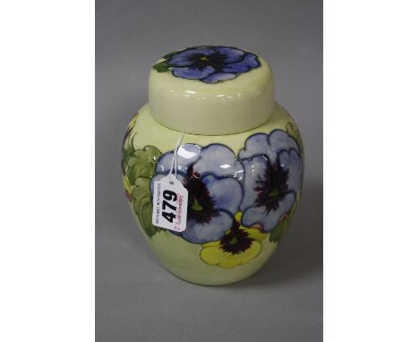 A MOORCROFT POTTERY GINGER JAR, Pansy pattern on yellow ground, paper label to base and lid, impressed mark, height approxima
