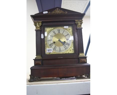 AN EARLY 20TH CENTURY WALNUT STAINED BRACKET CLOCK, architectural form, Roman numerals, gong strike with key and pendulum