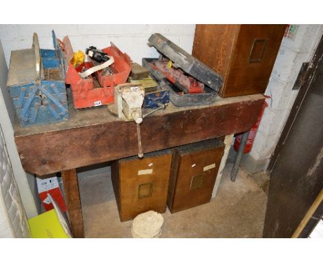 A WOODEN WORK BENCH, and two vices