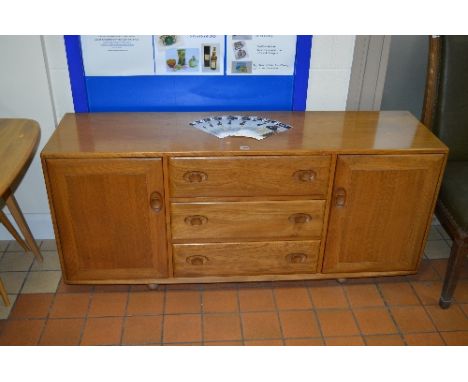 AN ERCOL ELM SIDEBOARD, with three central drawers, approximate size width 155.5cm x height 68cm x depth 43cm