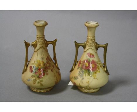TWO SMALL ROYAL WORCESTER BLUSH IVORY TWIN HANDLED BUD VASES, florally decorated, puce backstamps and No.1021, height approxi