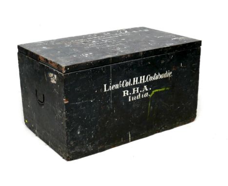 A large Edwardian pine travelling chest, painted black with inscribed white lettering 'Lieut Col H. H. Costobadie, R. H. A., 