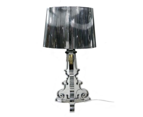 A Kartell Bourgie perspex table lamp, silvered finish, designed by Ferruccio Laviani, 32 by 69cm high. 