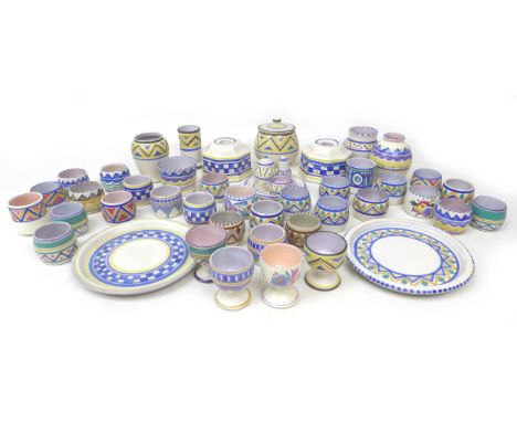 A large collection of Poole pottery, including plates, egg cups, candlestick holders and lidded pot. (46) 