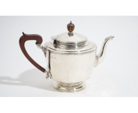 An Art Deco three piece silver tea service, by Selfridge &amp; Co, Birmingham 1930, of panelled circular form, the teapot wit
