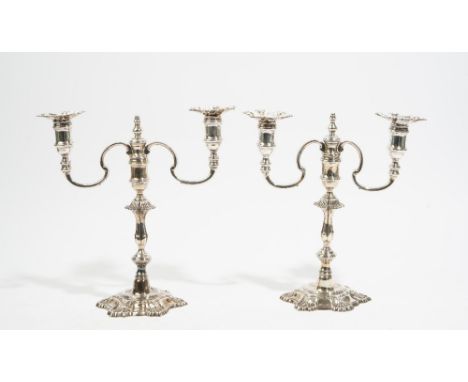 A pair of George II style cast silver twin light table candelabrum, by J B Chatterley & Sons, Birmingham 1965, with baluster 