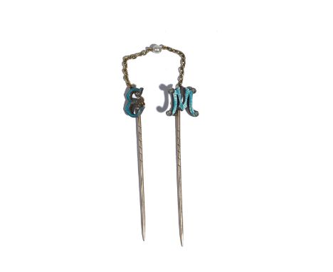 Two diamond set and pale blue enamelled stick pins, one designed as the initial 'E', the other designed as the initial 'M', t