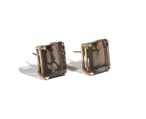 A pair of gold and smoky quartz-set earstuds, the rectangular cut-cornered step cut smoky quartz, four claw-set to gold mount