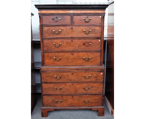A George III satinwood and kingwood banded mahogany chest on chest with two short over six long drawers divided by brushing s
