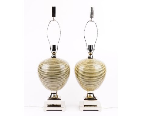 A pair of modern ceramic table lamps of ovoid form, raised on stepped chrome bases, with shades, 55cm high. 