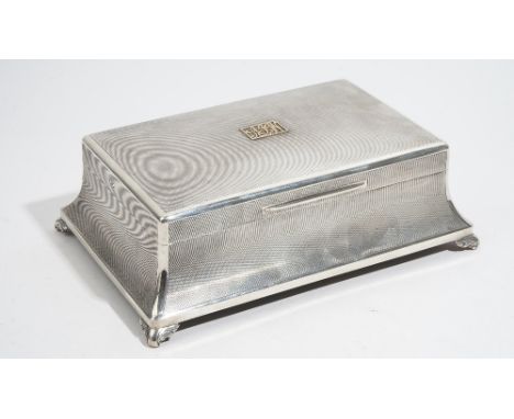 A silver table cigar/cigarette box, of swept rectangular form, wooden lined within with two adjustable divisions, the interio