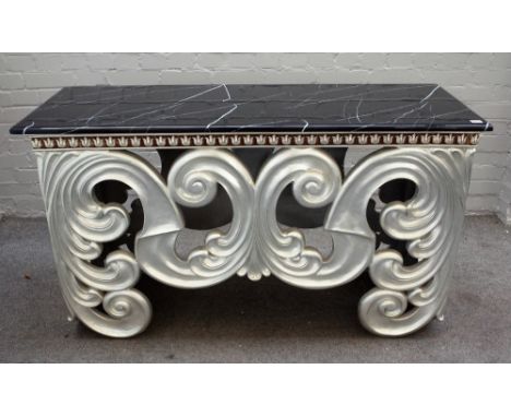 A modern console table, the faux rectangular marble top over a silver painted base of bold acanthus scrolls, 138cm wide x 79c