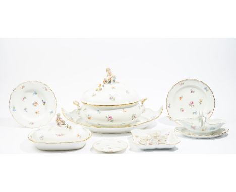 A Meissen porcelain part dinner service, circa 1880, each piece painted with scattered flowers inside a gilt-edged wavy rim, 