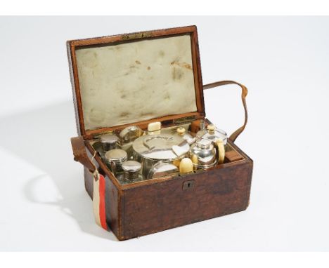 A Victorian leather cased travelling tea set, comprising; two silver spoons, London 1876 and a silver lid to one glass jar, L