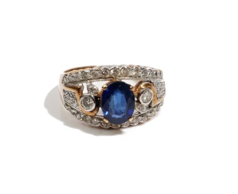 A gold, sapphire and diamond ring, in a tapered panel shaped design, claw set with an oval cut sapphire and otherwise set wit