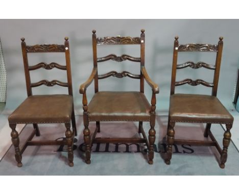 A set of three Charles II style oak ladder back dining chairs, to include a carver, together with two 19th century carved oak