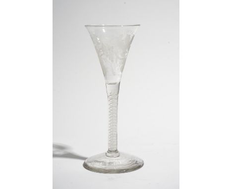 An opaque twist wine glass, circa 1765, the drawn trumpet bowl engraved with fruiting vine and an insect, raised on a double 