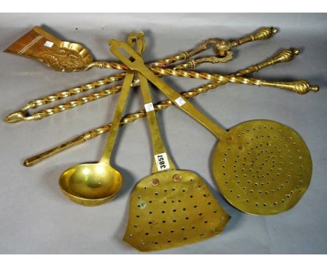 A quantity of 19th century brass fire tools, (qty). 