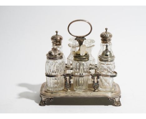 A silver eight bottle cruet frame, having an oval loop shaped handle, raised on four scrolled feet, probably London 1827, wei