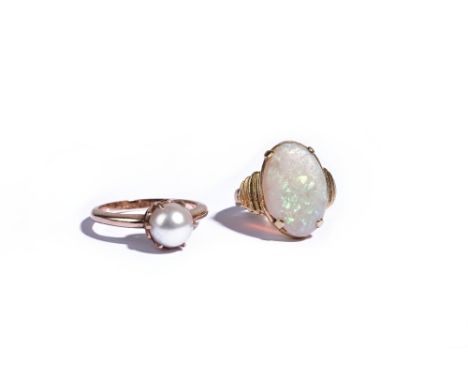 A gold ring, claw set with an oval opal, apparently unmarked, ring size I and a gold ring, claw set with a single cultured pe