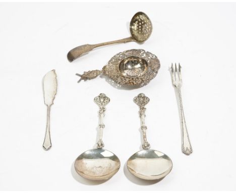 Silver, comprising; a pair of spoons, having circular bowls and with cast decoration to the handles, London 1897, a tea strai