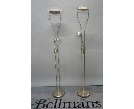 A pair of modern chrome uplighters of tubular form with a mid-tier adjustable reading light and frosted glass dished shades, 