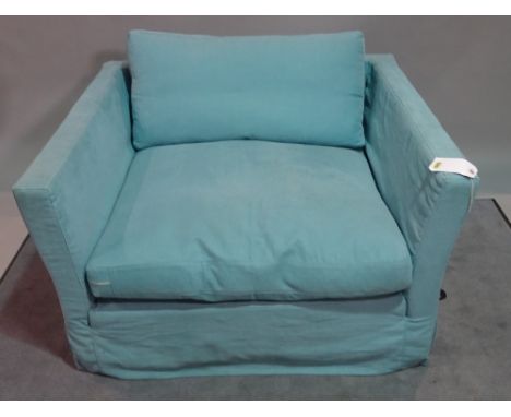 A modern low armchair, with light blue upholstery, 119cm wide x 66cm high. 