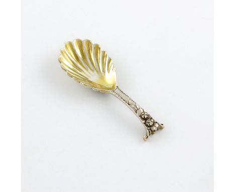 A Victorian cast silver caddy spoon, by George Adams, London 1855, gilded fluted bowl, with a cast foliate Onslow pattern sha
