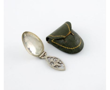 A silver folding medicine /caddy spoon, unmarked, circa 1900, oval bowl, the hinged handle pierced with a fleur-de-lis, in a 