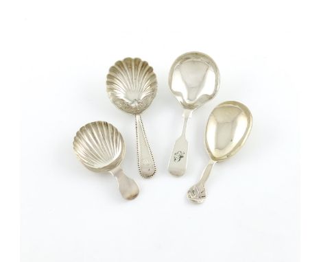 A collection of four antique Exeter made silver caddy spoons, comprising: a Beaded pattern one, by James and Josiah Williams,