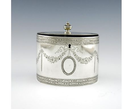 A George III silver tea caddy, by William Vincent, London 1785, oval form, flush-hinged cover with an urn finial, engraved de