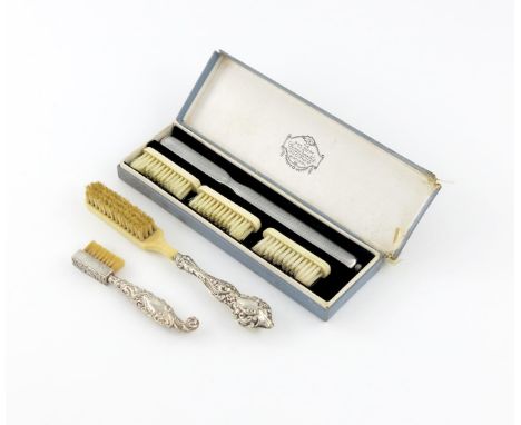 λ A silver toothbrush, retailed by Gomersall's, London 1926, shaped rectangular form, engine-turned decoration, with three de